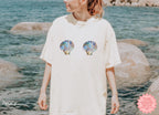 Stylish ivory seashell graphic tee for beach-inspired vibes.