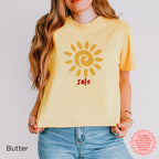 Full outfit: Woman styling the cream SOLE graphic T-shirt with relaxed denim for a casual, Mediterranean-inspired summer look.