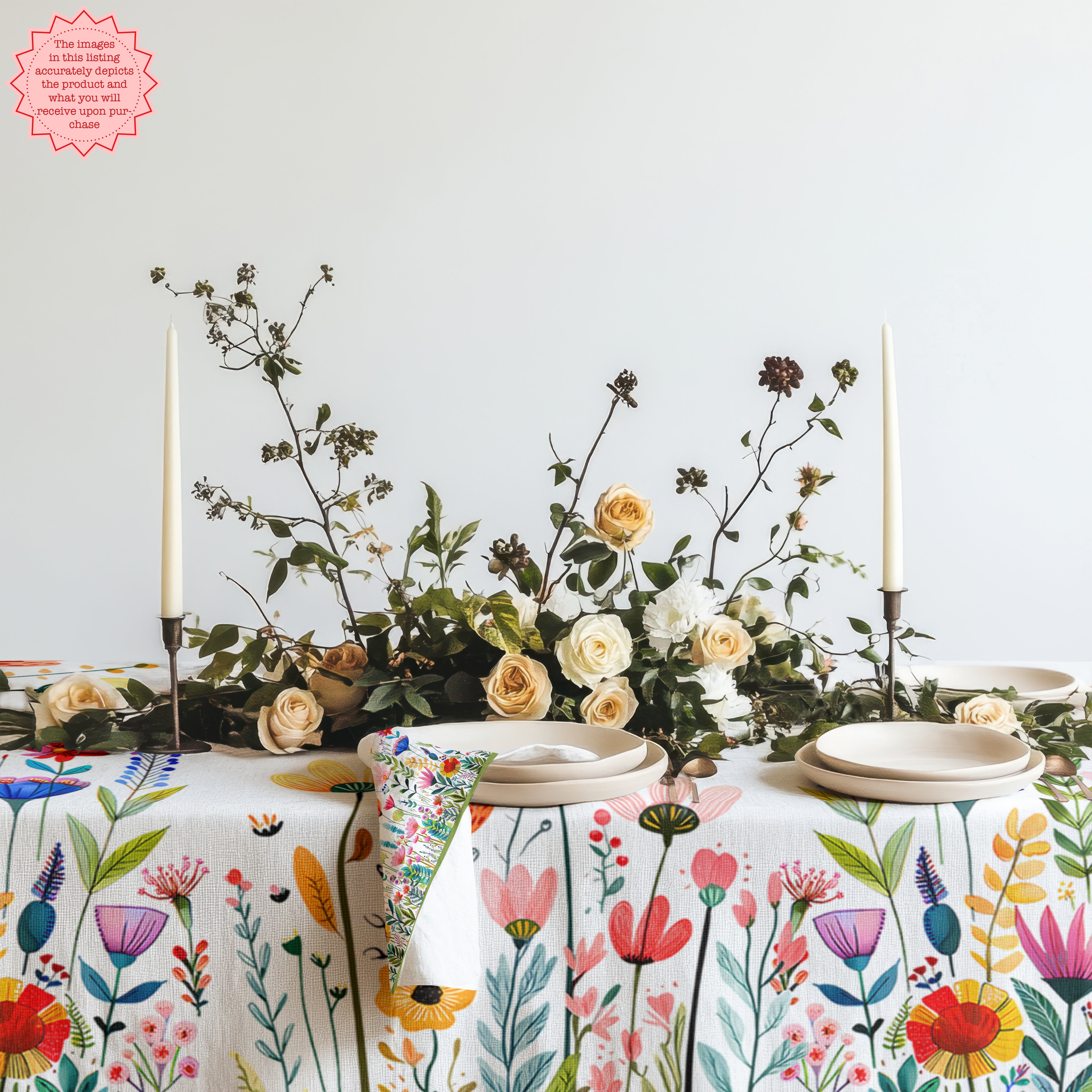 Colourful Mediterranean wildflower meadow tablecloth featuring hand-drawn floral illustrations styled on a modern dining table with neutral ceramics