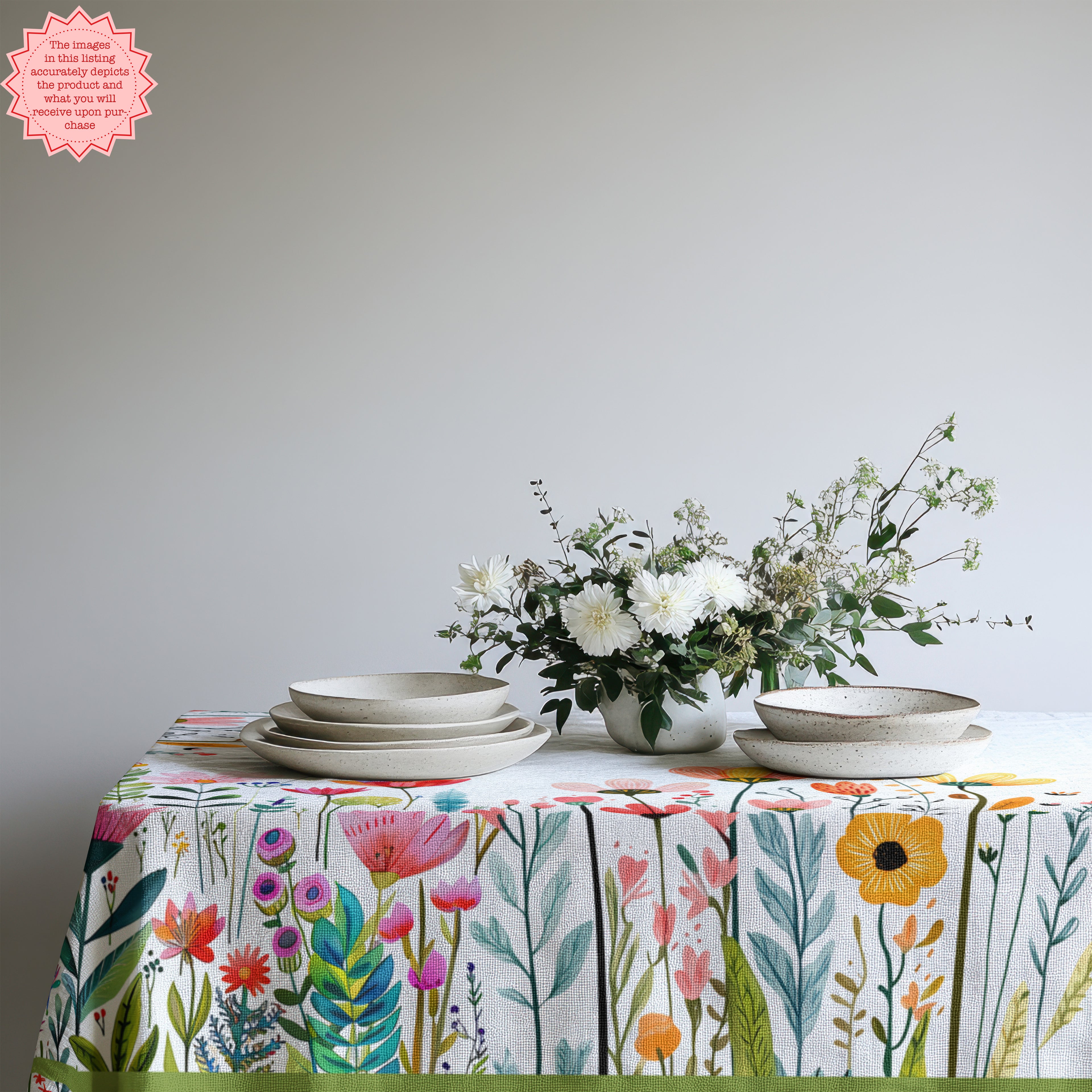 Summer dining table styled with Mediterranean wildflower tablecloth and neutral tableware for relaxed entertaining