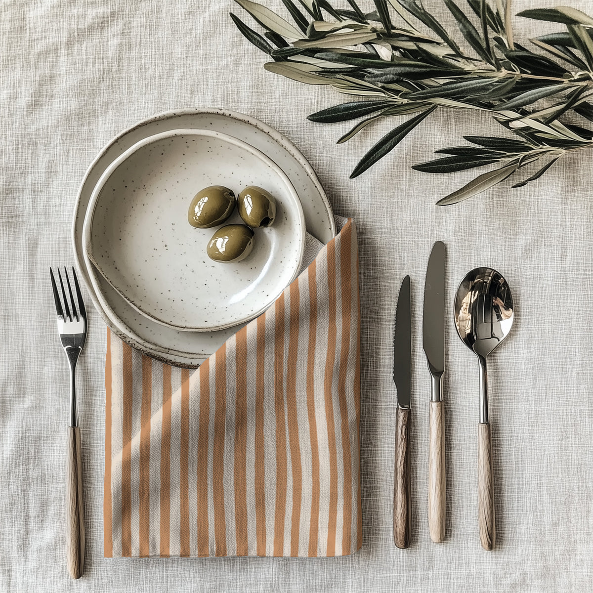 Terracotta Stripes Table Napkin styled on an elegant dining table with neutral tableware and natural accessories.