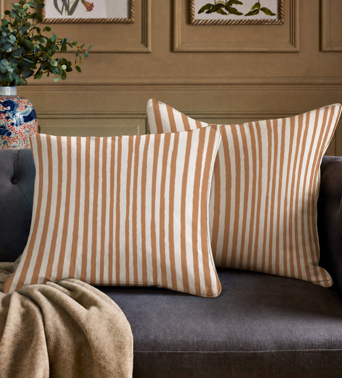 Front view of a terracotta Halloween decorative cushion cover featuring colourful artwork and hand-drawn stripes.