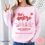 Custom ‘That’s Amore’ Bachelorette Sweatshirt in Light Pink, personalized with bride’s name, location, and year.