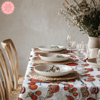 Tomato print cotton tablecloth styled on a modern dining table with ceramic plates and glassware