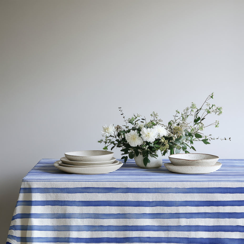 Watercolor nautical blue stripes tablecloth with soft Mediterranean-inspired design, featuring elegant blue and white stripes, perfect for coastal-themed dining spaces.