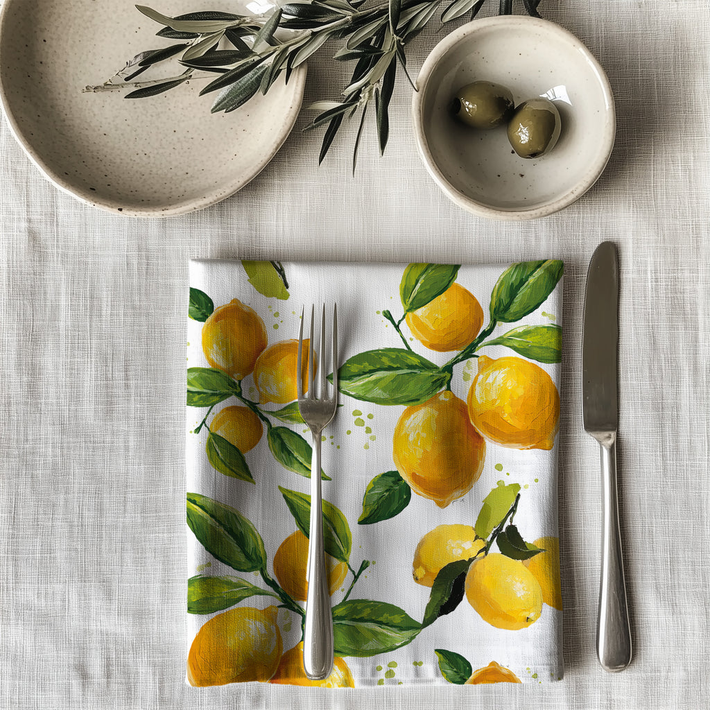 Single watercolor lemon dinner napkin folded on table showcasing one-sided print design and soft reusable cotton fabric