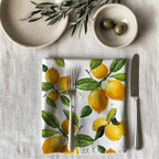 Single watercolor lemon dinner napkin folded on table showcasing one-sided print design and soft reusable cotton fabric