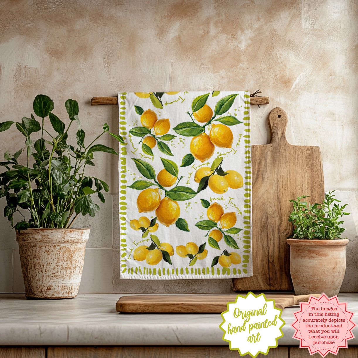 Hand-painted lemon tea towel hanging in a bright kitchen with wooden utensils and fresh greenery