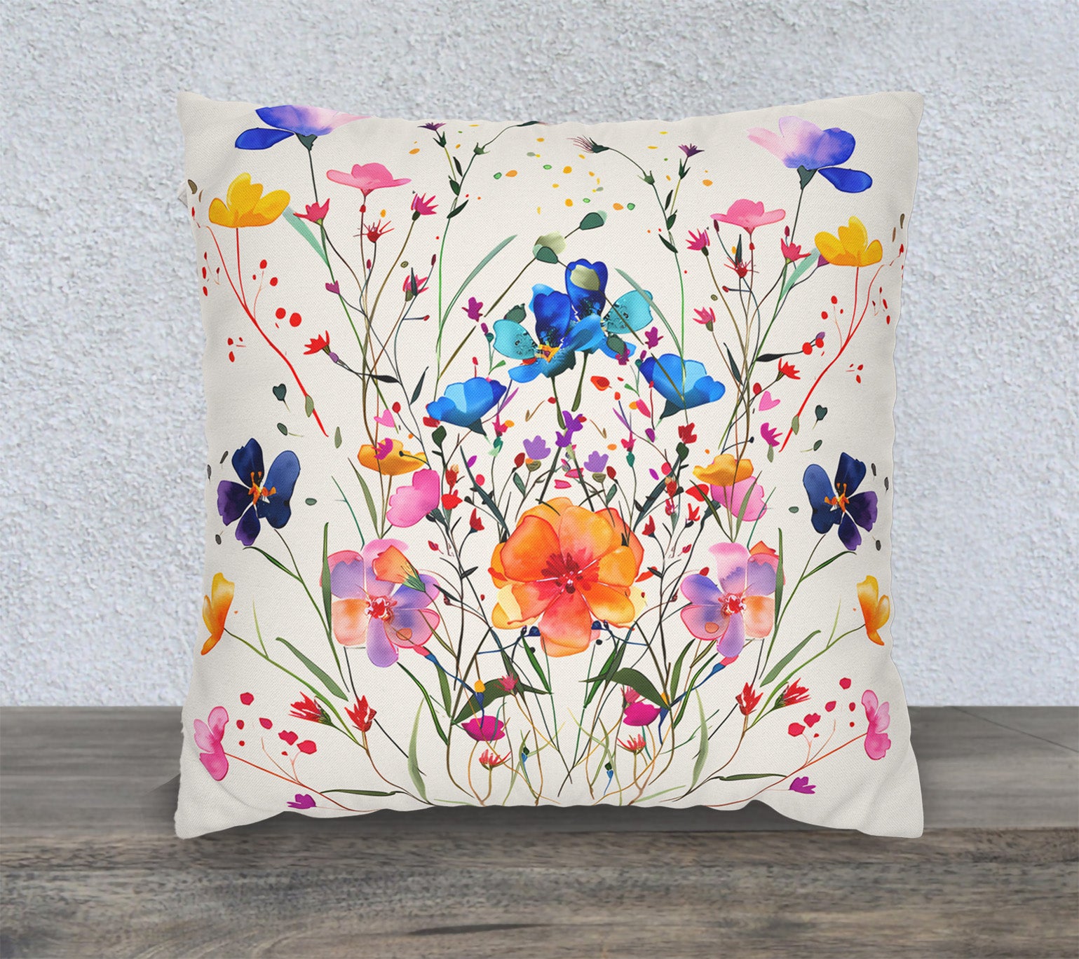 Watercolor wildflower throw pillow cover with colorful botanical floral artwork on a cream background.