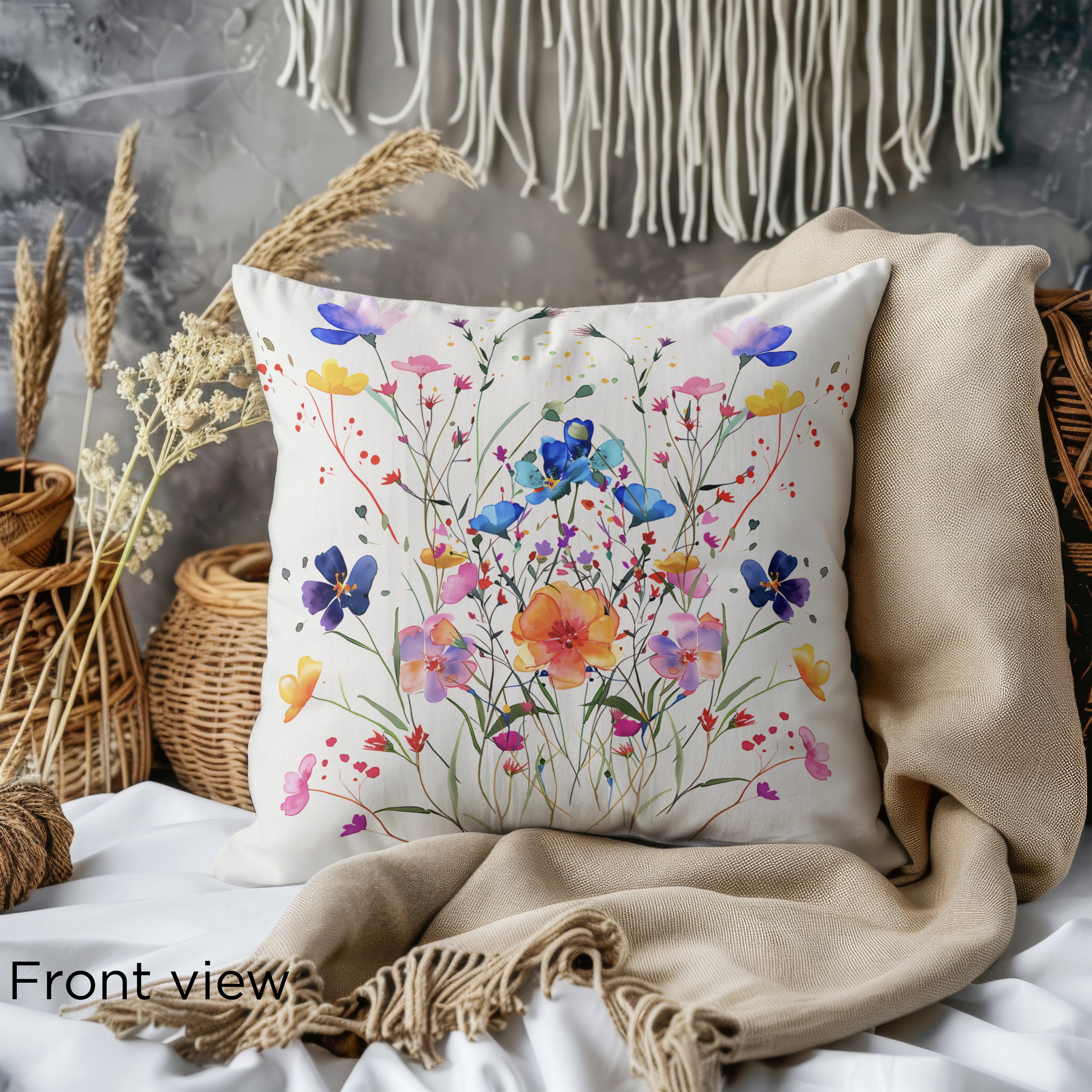 Decorative floral pillow cover showcasing hand-painted wildflowers in bright spring colors.
