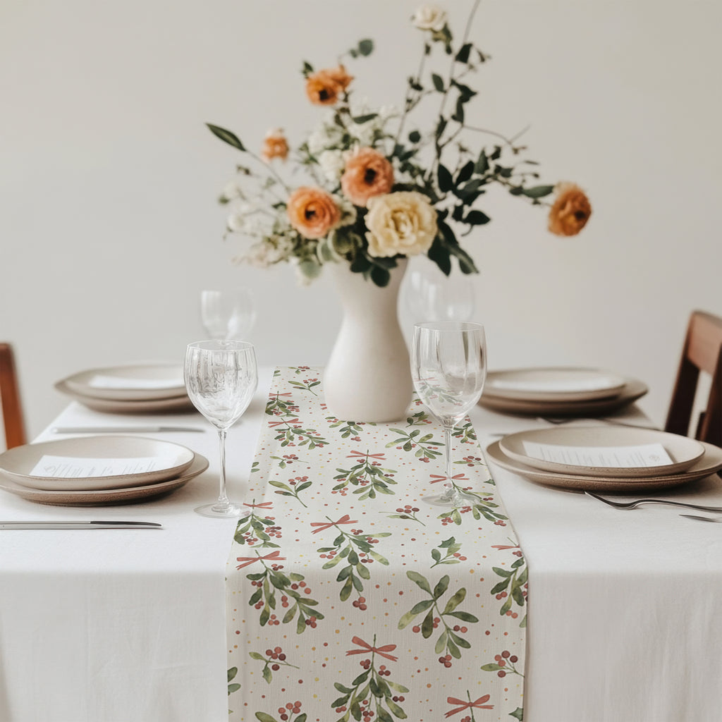 Festive Christmas table setting featuring a mistletoe table runner