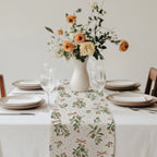 Festive Christmas table setting featuring a mistletoe table runner