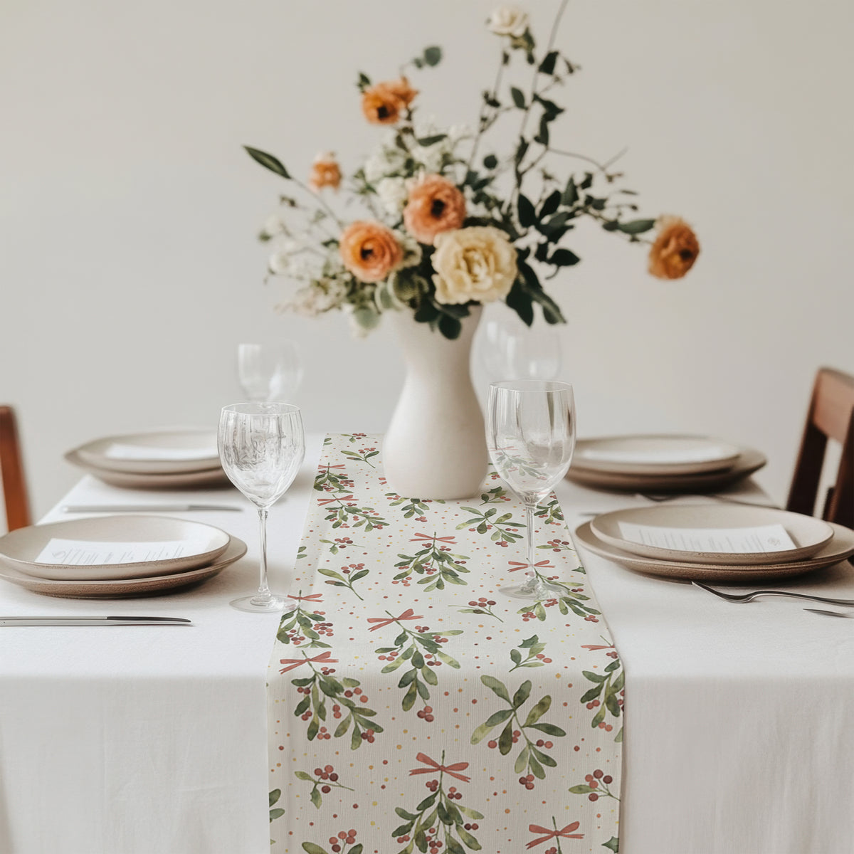 Festive Christmas table setting featuring a mistletoe table runner