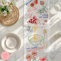 Italian Mediterranean table runner displayed on a rustic farmhouse dining table with neutral tableware.
